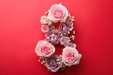 Photo of Number 8 made of beautiful flowers on red background, flat lay. International Women's day