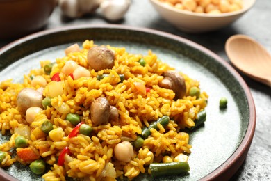Photo of Delicious rice pilaf with vegetables on table, closeup