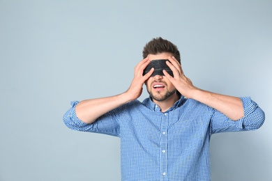 Photo of Man with black blindfold on grey background