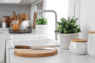 Photo of Different potted artificial plants on countertop in kitchen. Home decor