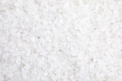 Photo of White sea salt as background, top view. Spa treatment