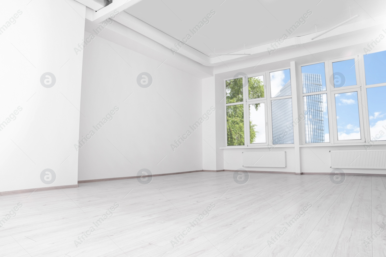 Photo of Modern office room with white walls and windows. Interior design