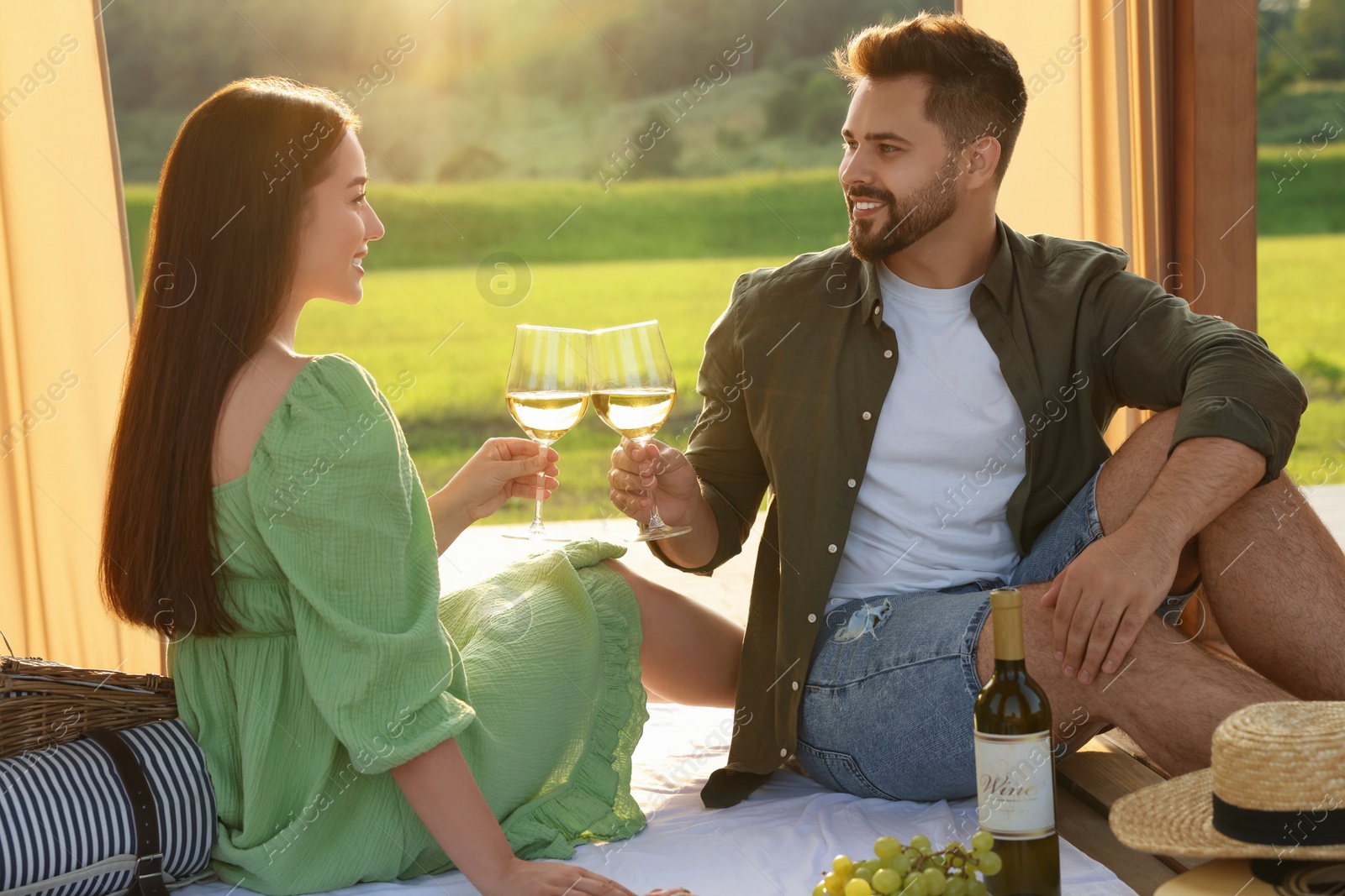 Photo of Romantic date. Beautiful couple having picnic outdoors on sunny day