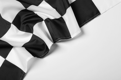 Photo of Checkered finish flag on white background, top view. Space for text