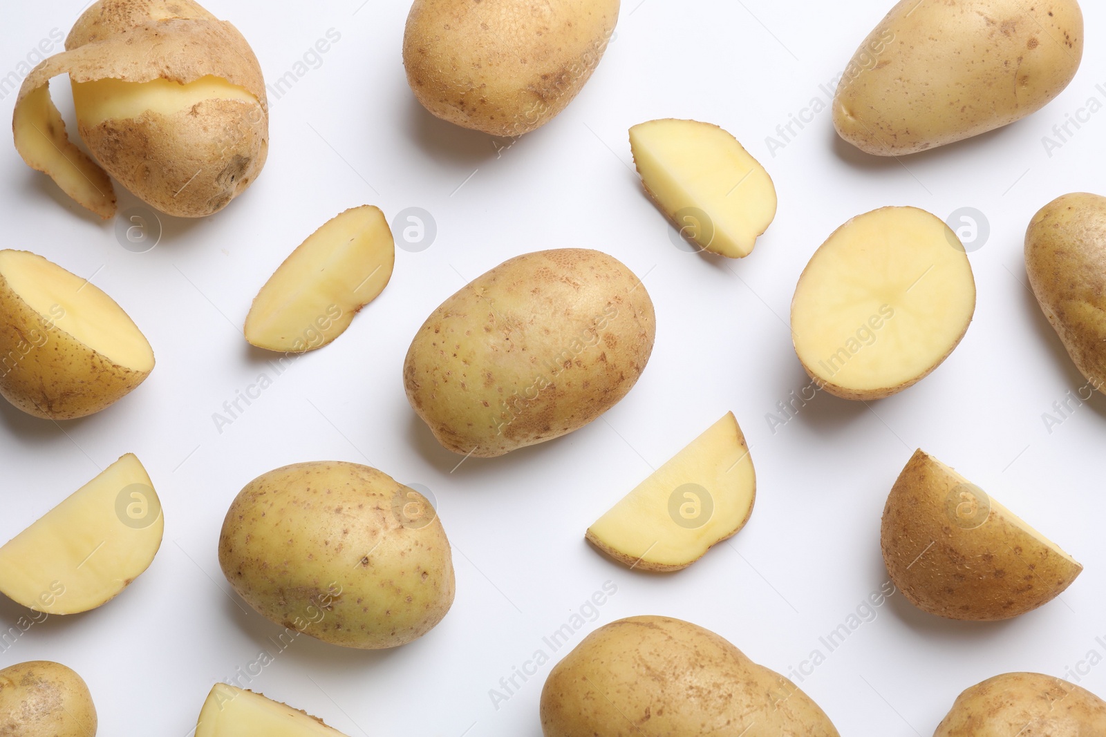 Photo of Fresh raw potatoes on white background, flat lay