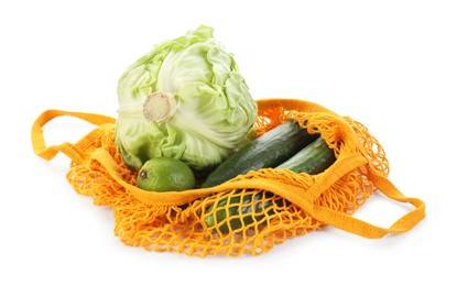 Photo of String bag with different vegetables isolated on white