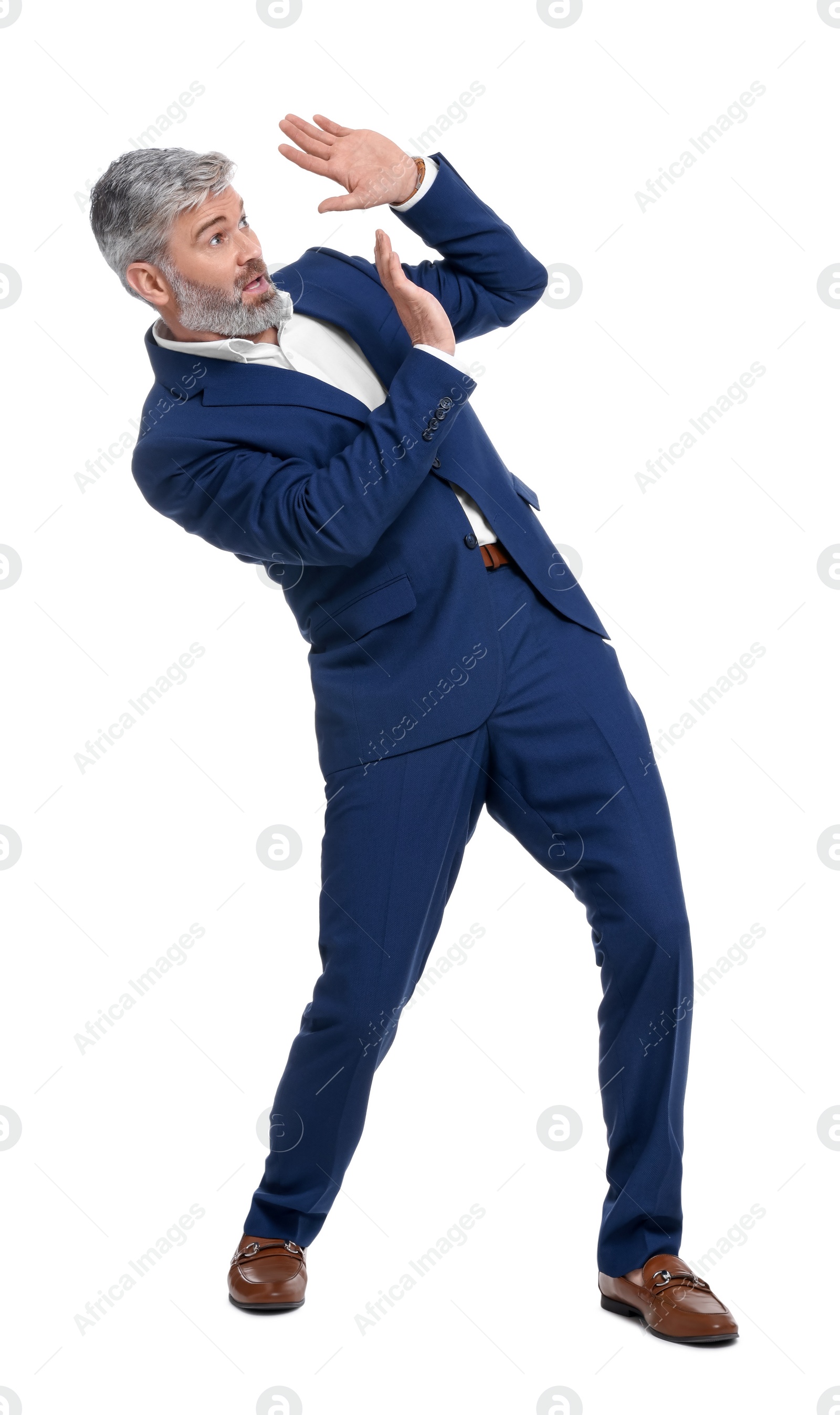 Photo of Mature businessman in stylish clothes avoiding something on white background