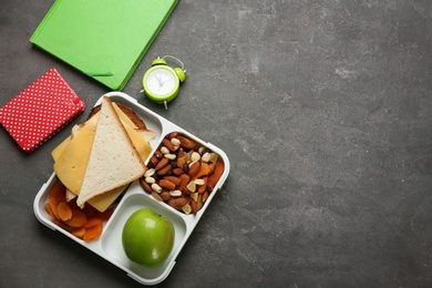 Photo of Flat lay composition with lunch box and appetizing food for school on grey background