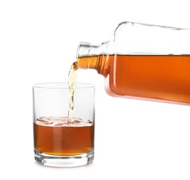 Photo of Pouring expensive whiskey into glass on white background