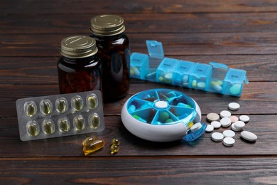 Photo of Pill boxes with medicaments on wooden table