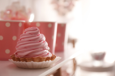 Delicious cake with pink cream for birthday party on white table, closeup. Space for text