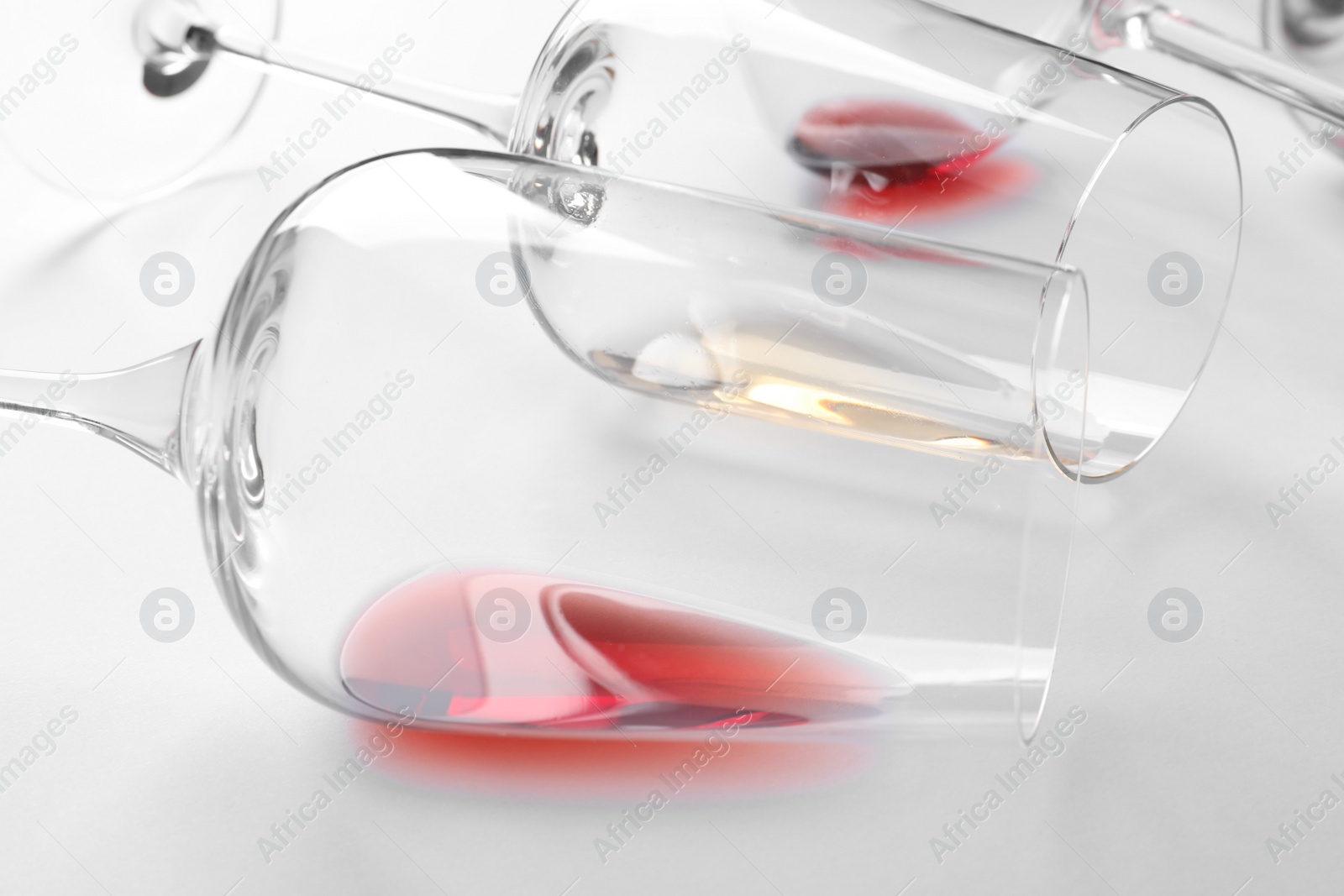 Photo of Glasses with different wine on white background, closeup