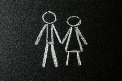 Figures of man and woman drawn on blackboard. Sex education