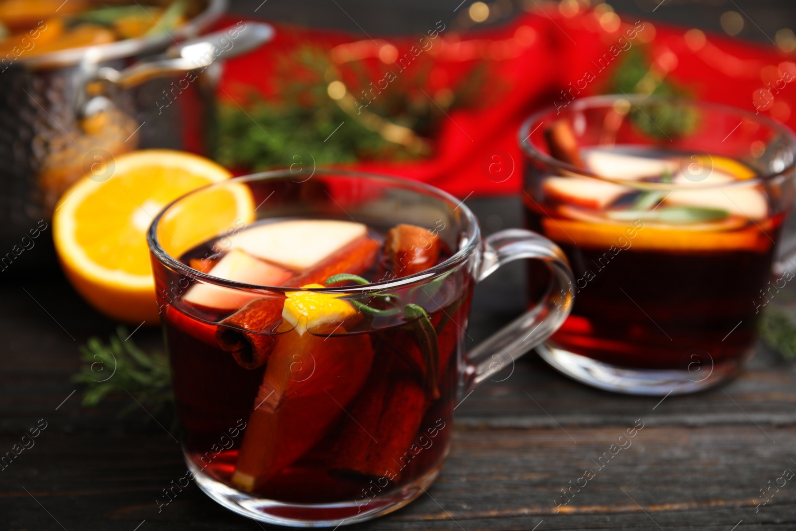 Photo of Tasty mulled wine with spices on wooden table