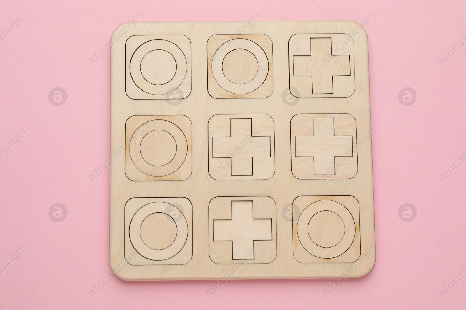 Photo of Tic tac toe set on pink background, top view