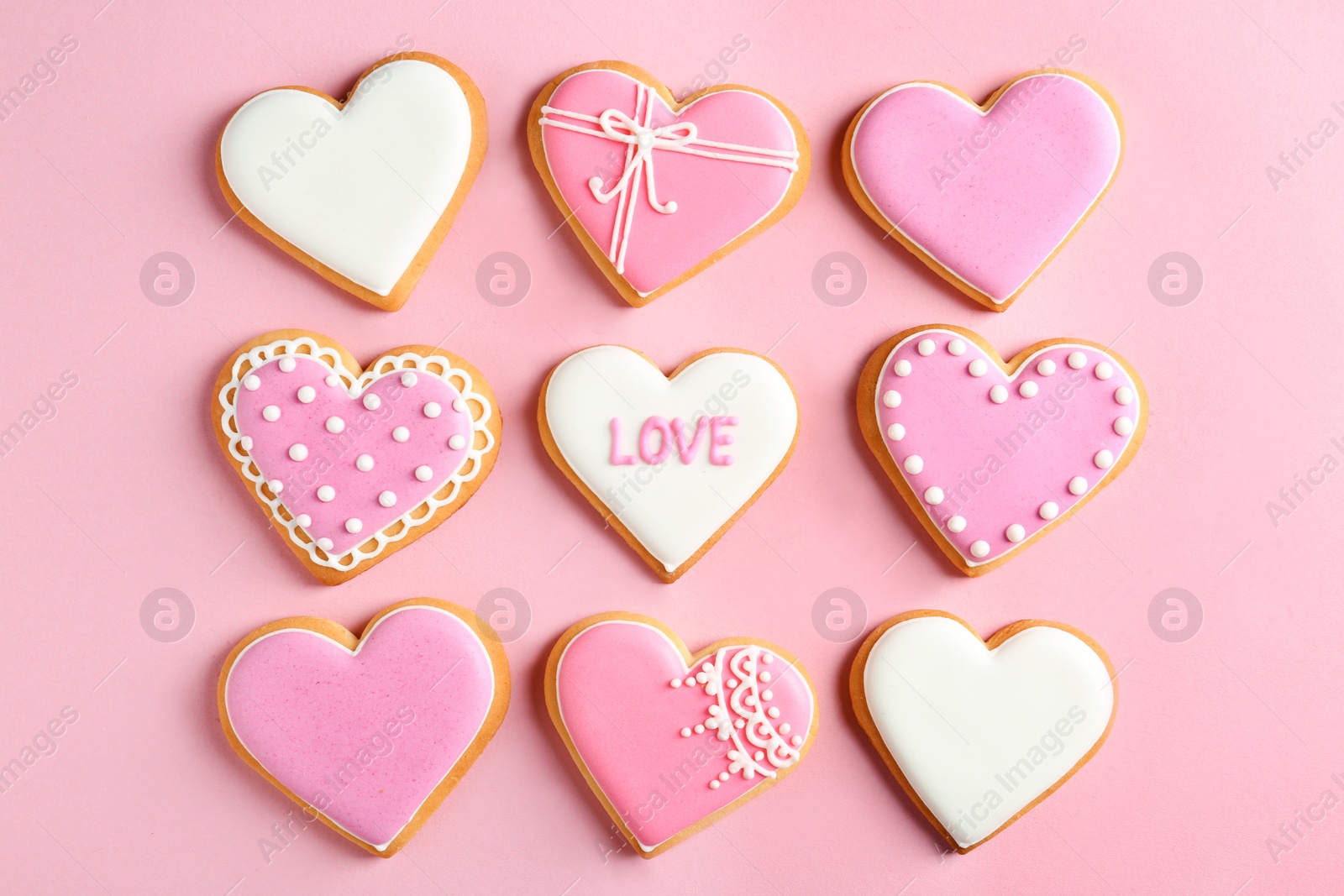 Photo of Decorated heart shaped cookies on color background, flat lay. Valentine's day treat