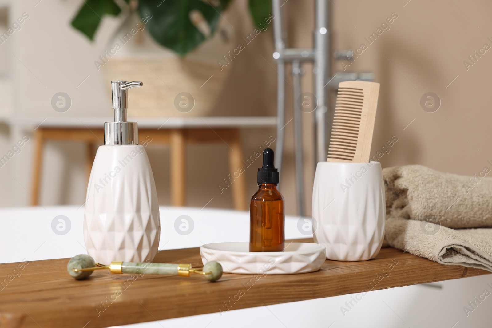 Photo of Different personal care products and accessories on bath tub in bathroom, closeup