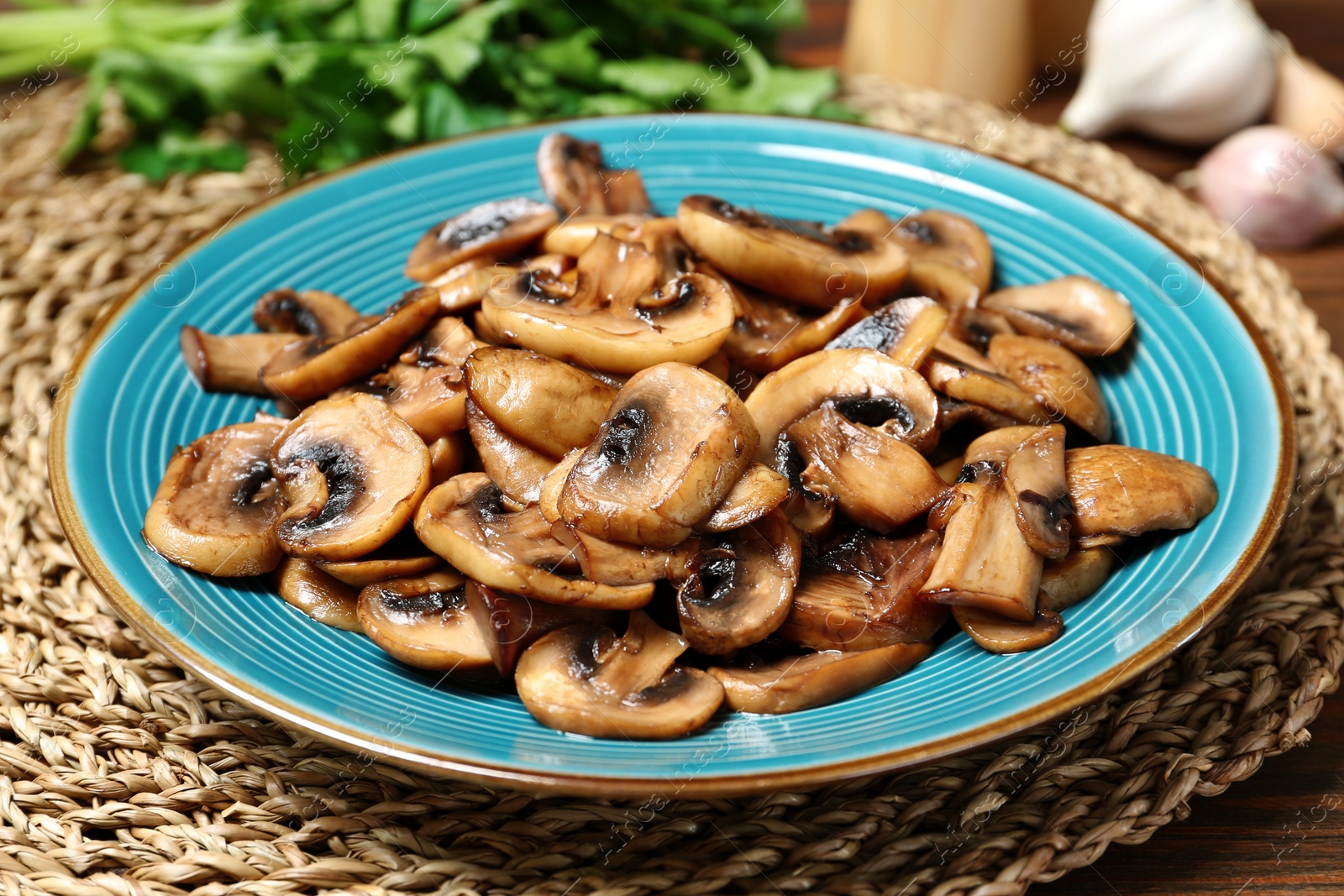 Photo of Plate of tasty fried mushrooms on table