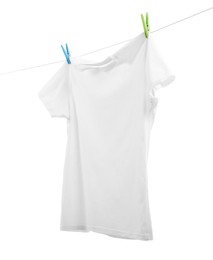 Photo of One t-shirt drying on washing line isolated on white
