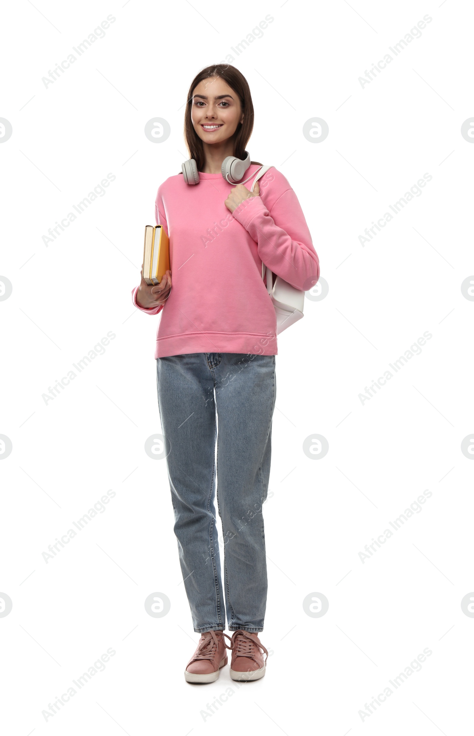 Photo of Teenage student with backpack, headphones and books on white background