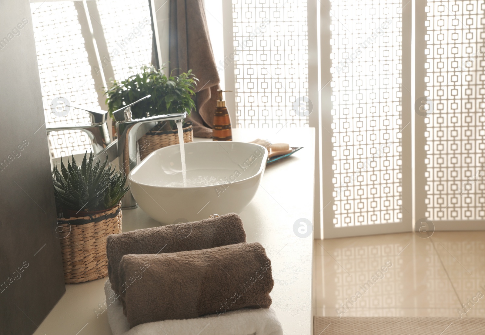 Photo of Modern bathroom interior with stylish mirror and vessel sink