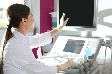 Photo of Sonographer using modern ultrasound machine in clinic