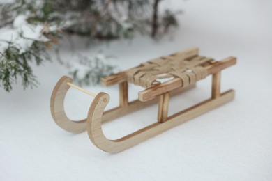 Beautiful decorative wooden sleigh on snow outdoors