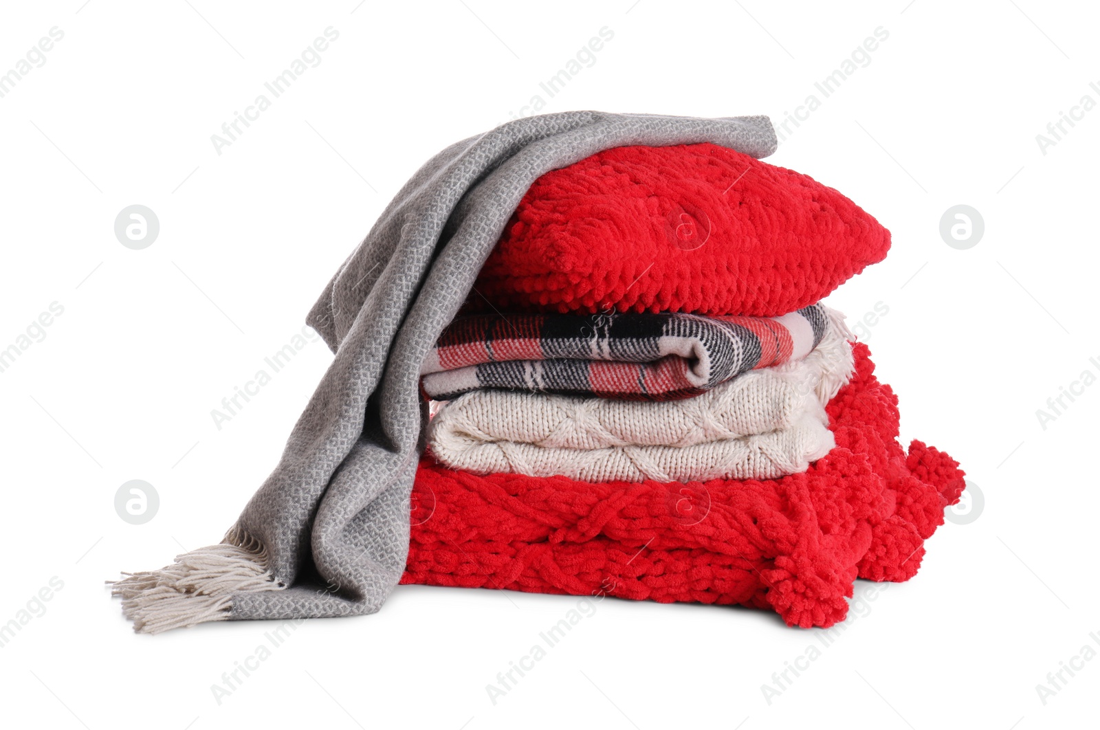 Photo of Stack of folded warm plaids with pillow on white background