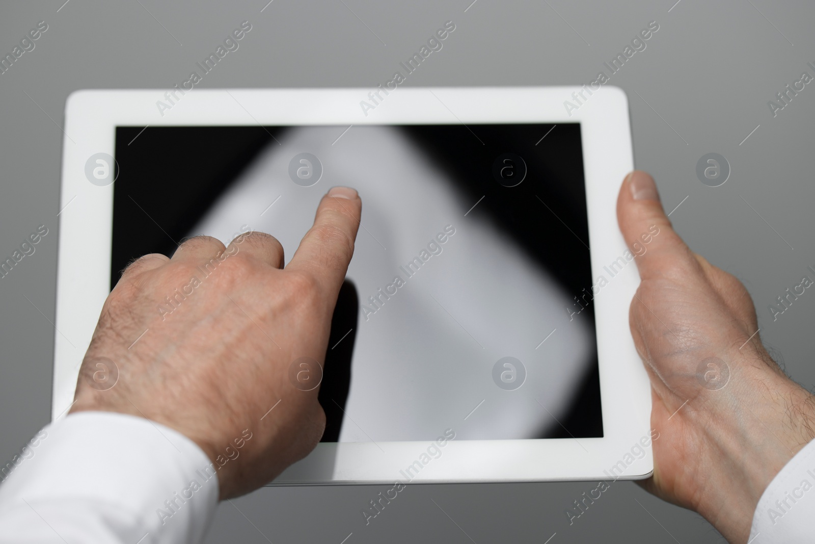 Photo of Closeup view of man using new tablet indoors