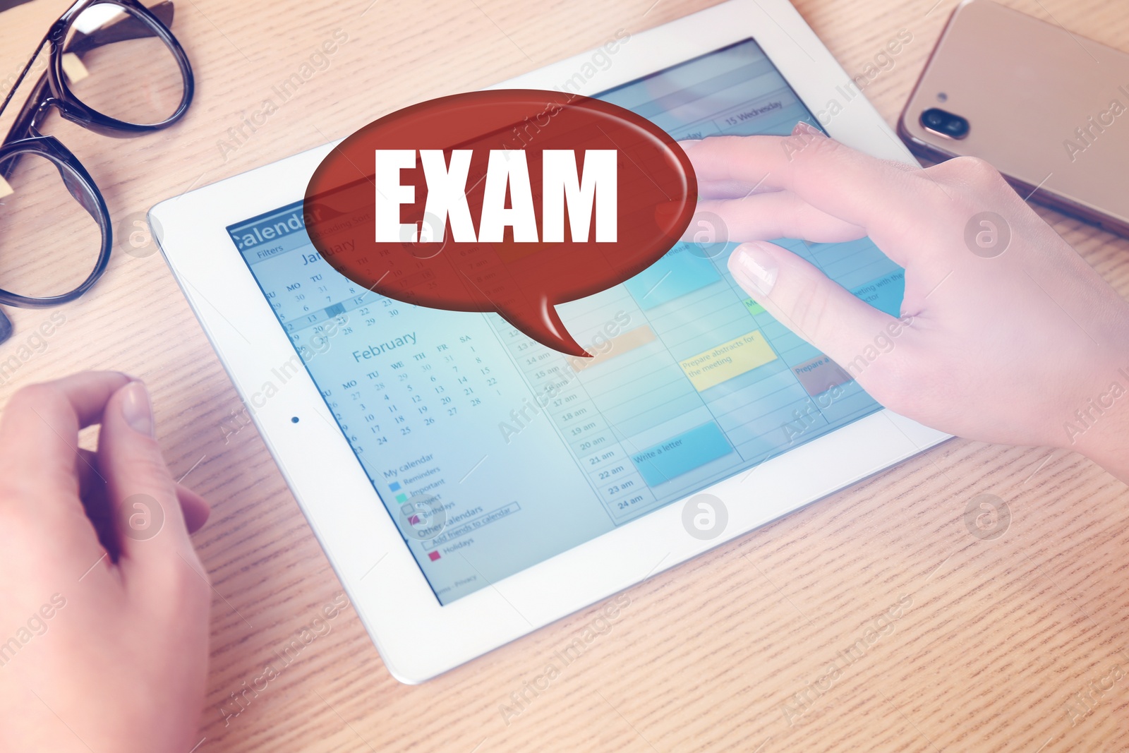 Image of Student using tablet at wooden table, closeup. Online exam