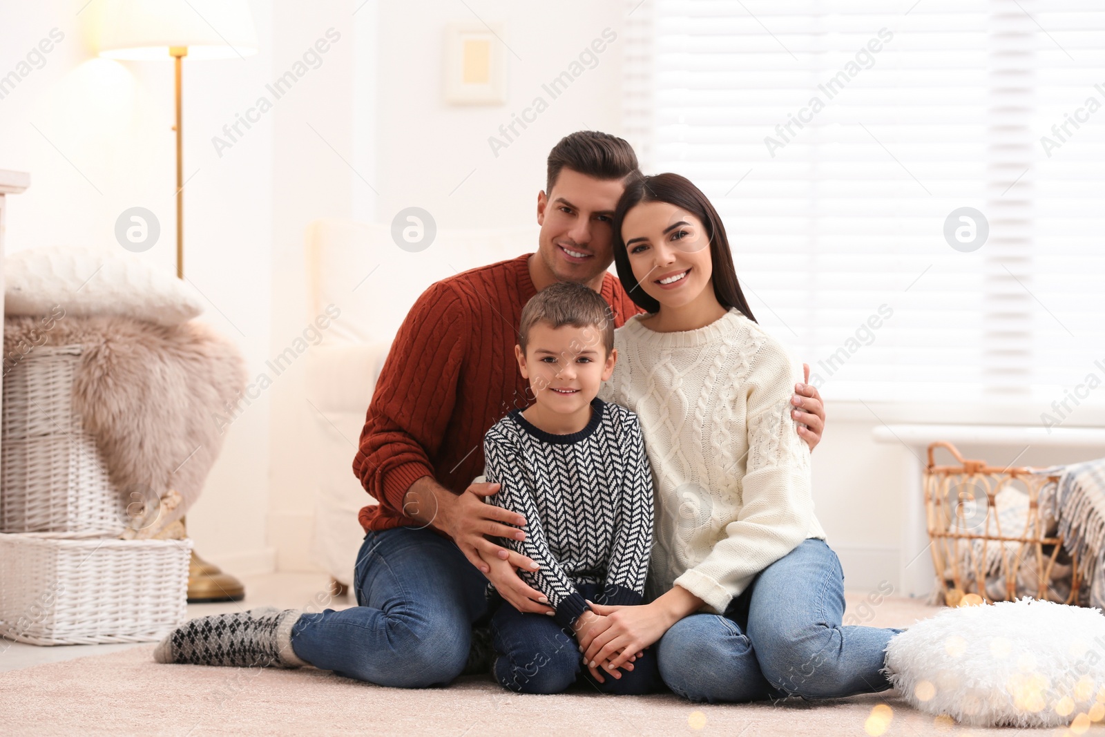 Photo of Happy family with little son spending time together at home. Winter vacation