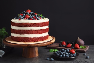 Photo of Composition with delicious homemade red velvet cake and space for text on black background