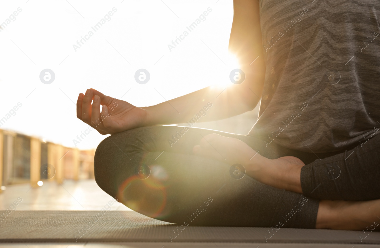 Photo of Woman practicing yoga on floor against window, closeup. Space for text