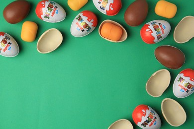 Photo of Sveti Vlas, Bulgaria - June 29, 2023: Kinder Surprise Eggs and plastic capsules on green background, flat lay. Space for text