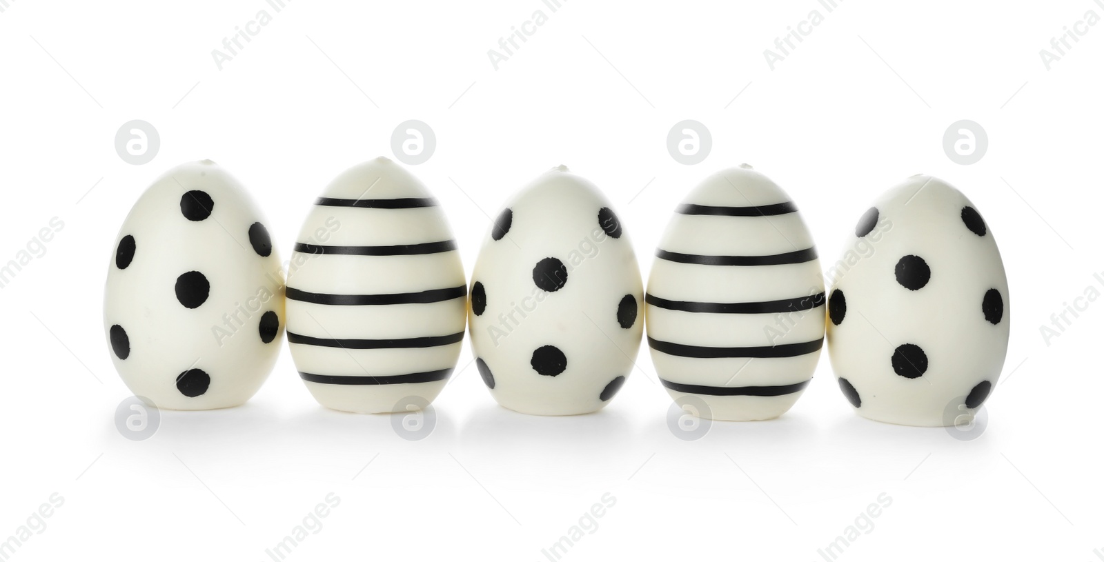 Photo of Line of traditional Easter eggs decorated with black paint on white background