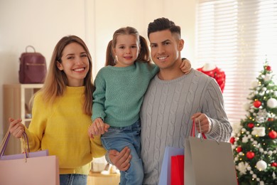Happy family doing Christmas shopping in store
