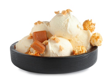 Plate of delicious ice cream with caramel candies and popcorn on white background