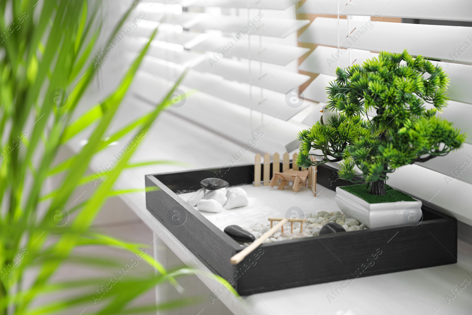 Photo of Beautiful miniature zen garden on window sill