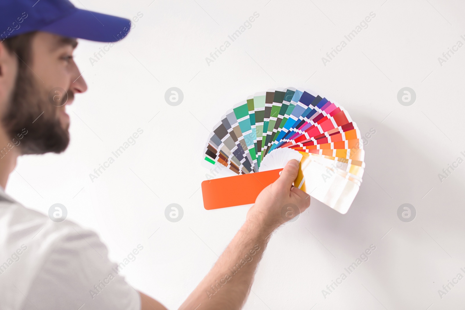 Photo of Male decorator with color palette on white background