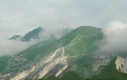 Picturesque landscape with mountains under thick fog