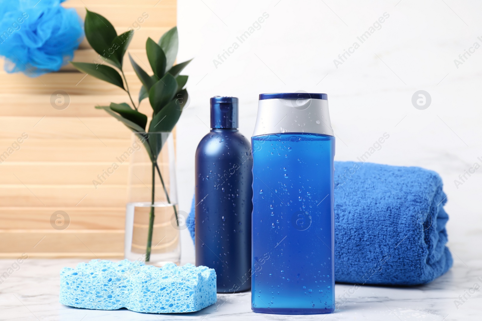 Photo of Cosmetic products and towel on white marble table. Men's hygiene