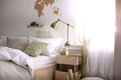 Modern eco style interior with wooden crates and comfortable bed