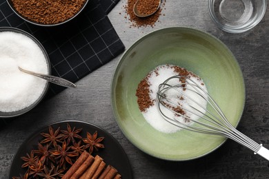 Photo of Making dalgona coffee. Instant granules, sugar, cinnamon sticks, anise stars and whisk on table, flat lay