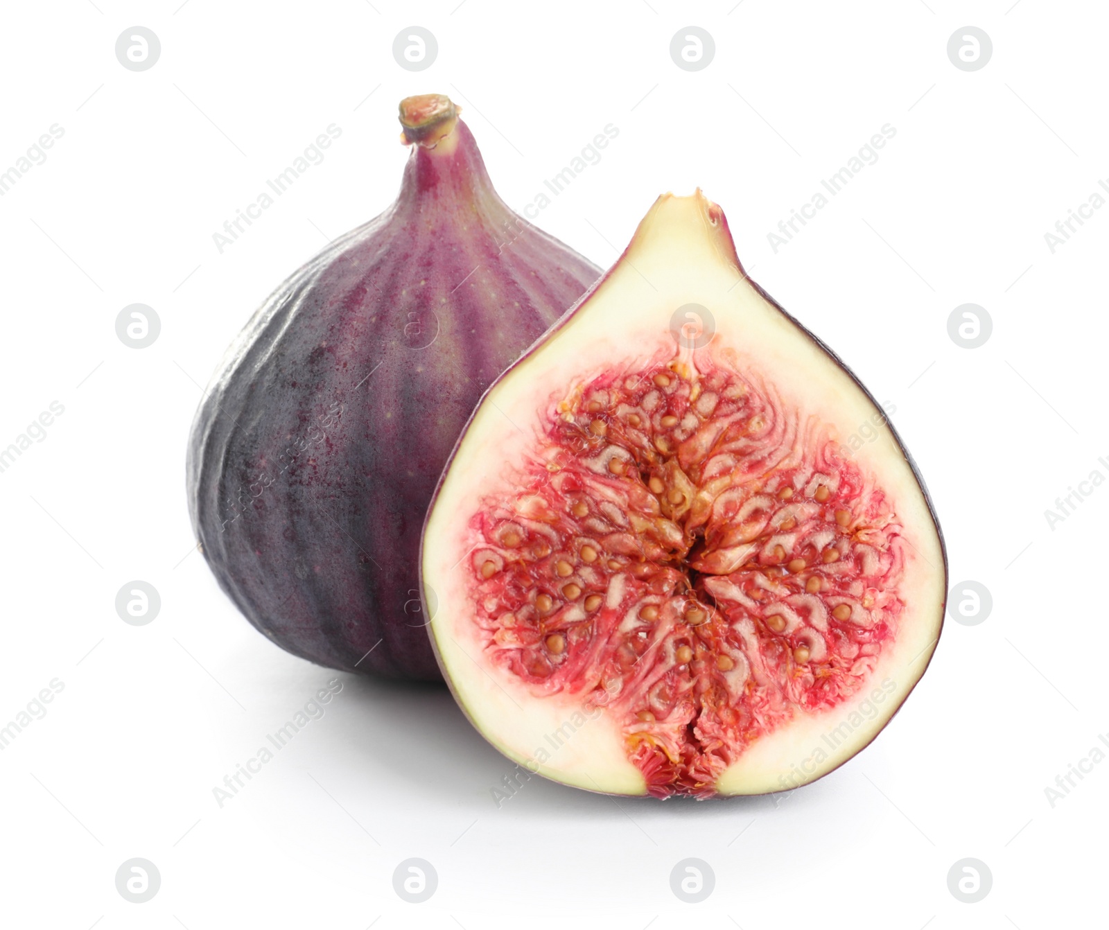 Photo of Whole and cut purple figs on white background