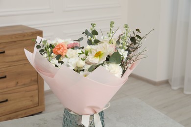 Bouquet of beautiful flowers on light grey table indoors