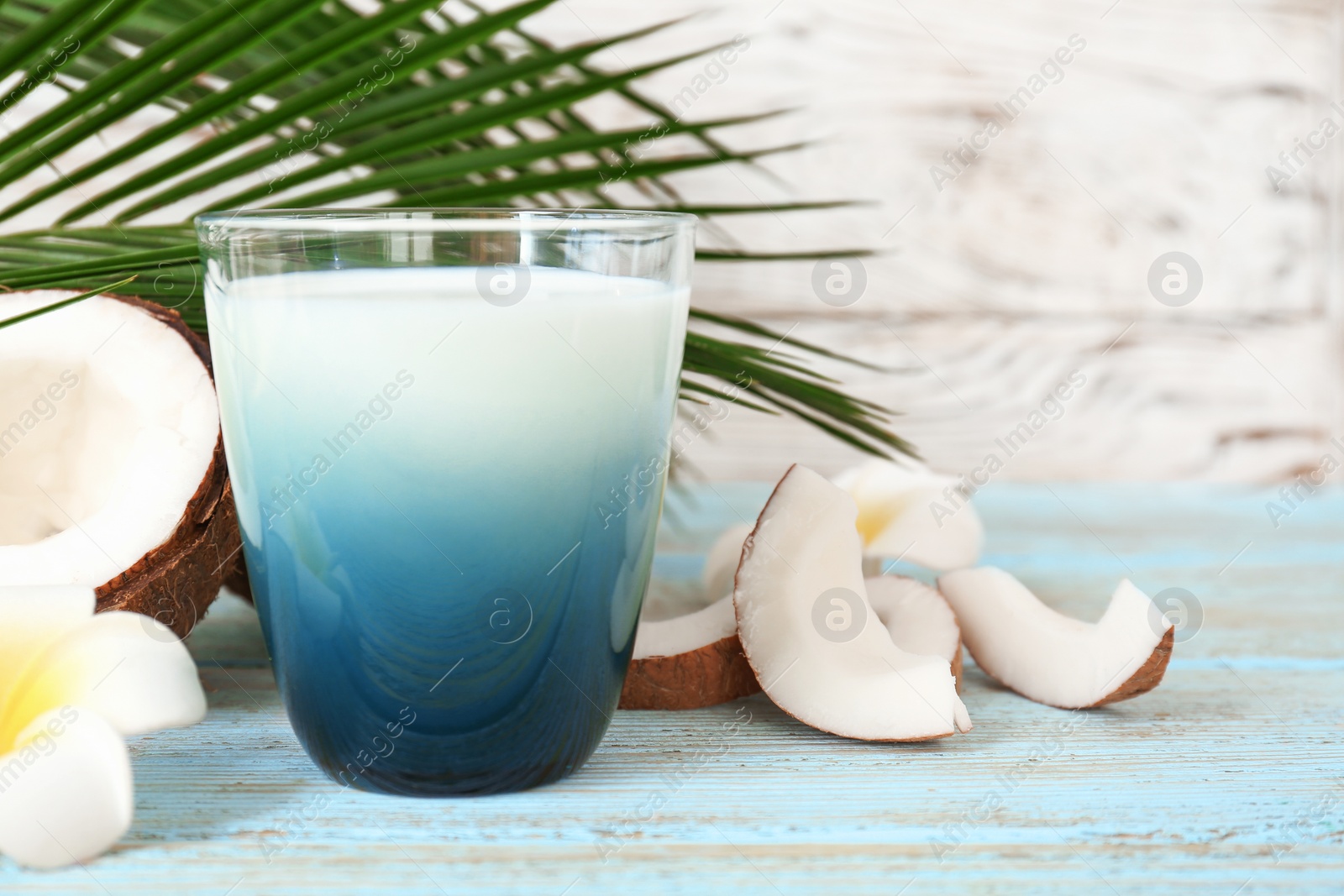 Photo of Glass of coconut milk on wooden table