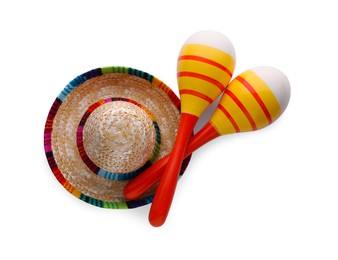 Photo of Colorful maracas and sombrero hat isolated on white, top view. Musical instrument