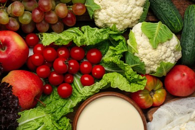 Photo of Different fresh ripe vegetables, sour cream and fruits as background, top view. Farmer produce