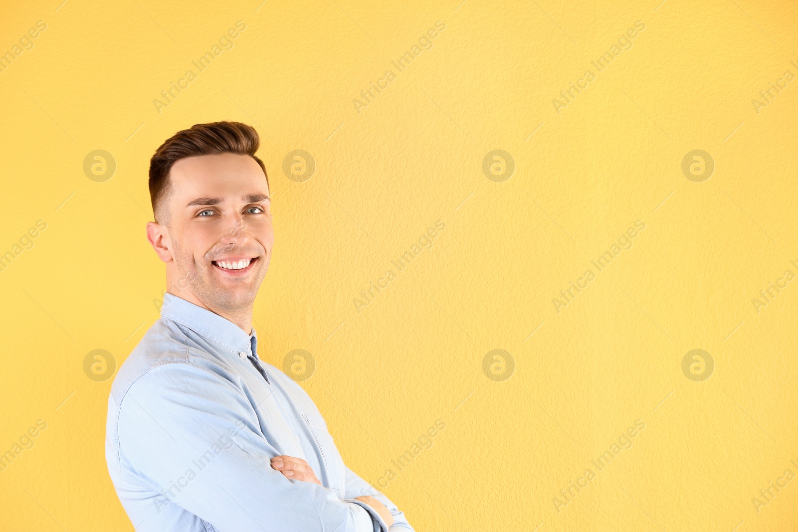 Photo of Portrait of young man with beautiful hair on color background