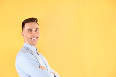 Portrait of young man with beautiful hair on color background